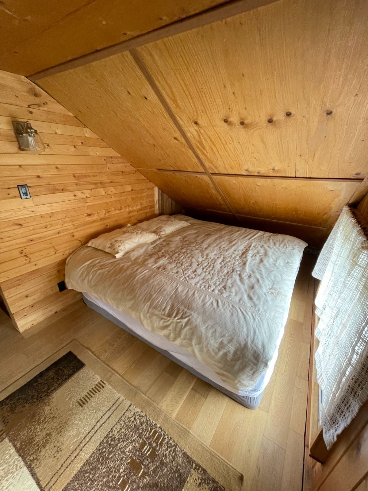 Cosy loft bedroom under the wood eaves