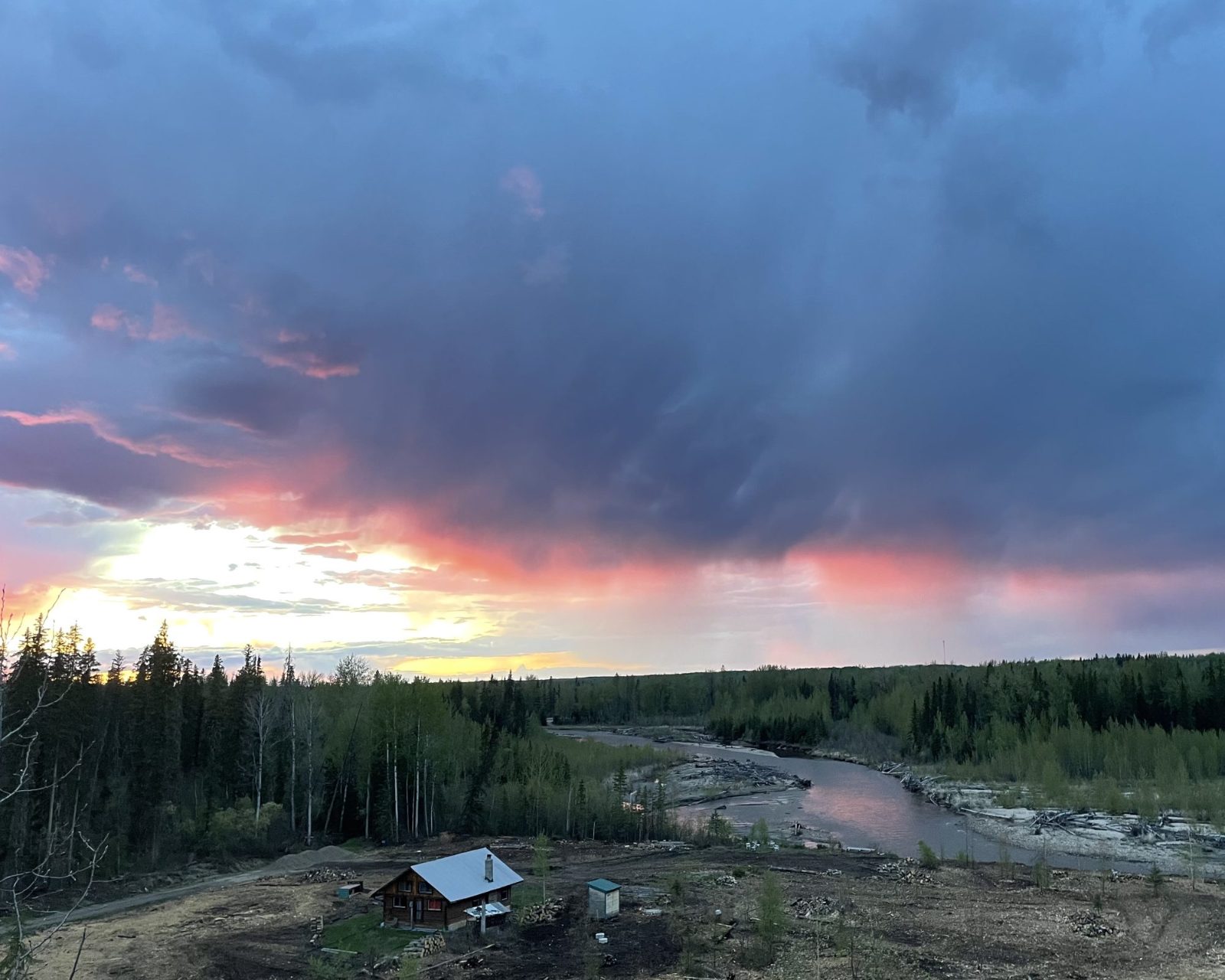 Aerial view of the cabin and the Freeman River at sunset