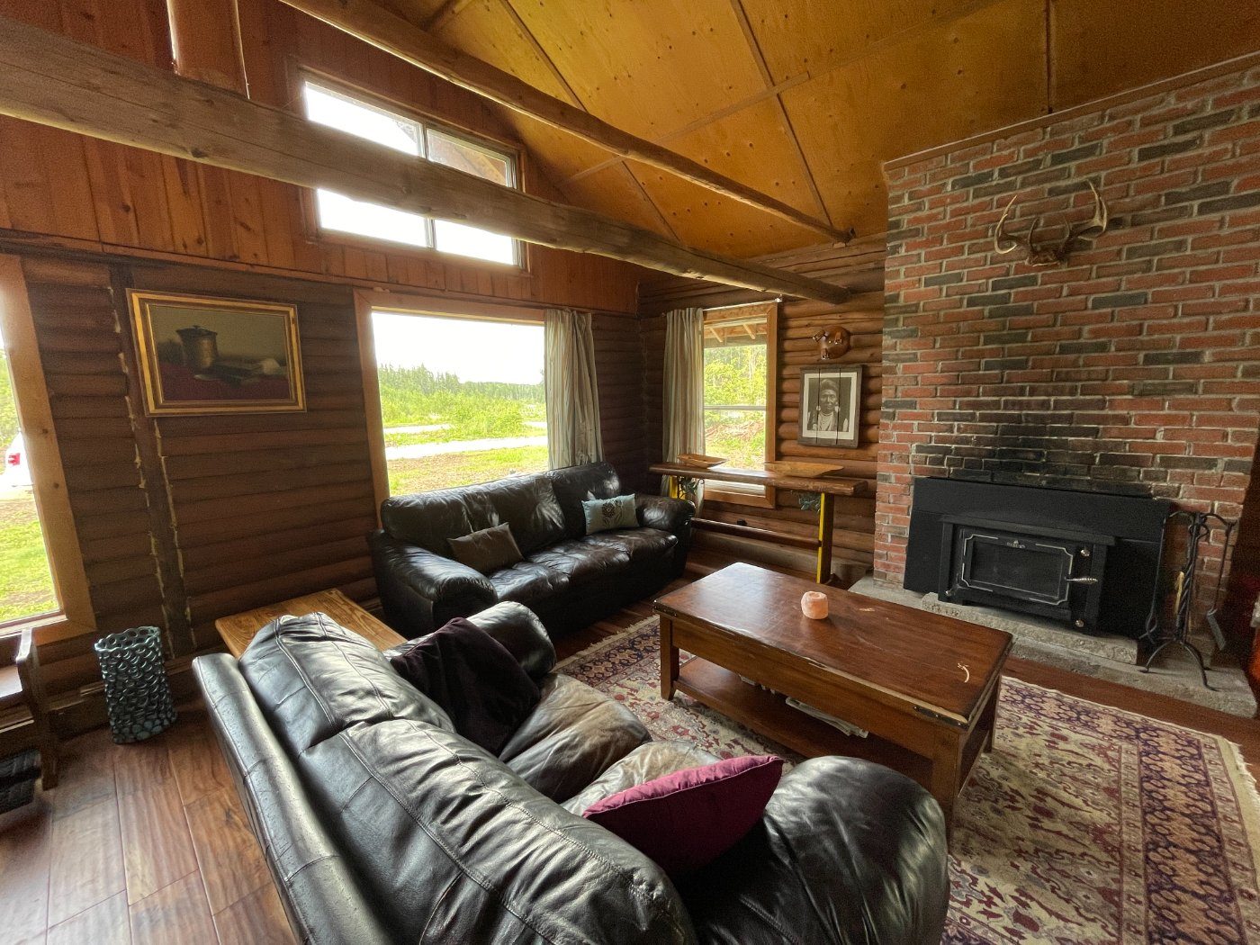 Leather sofas gathered around the brick woodstove