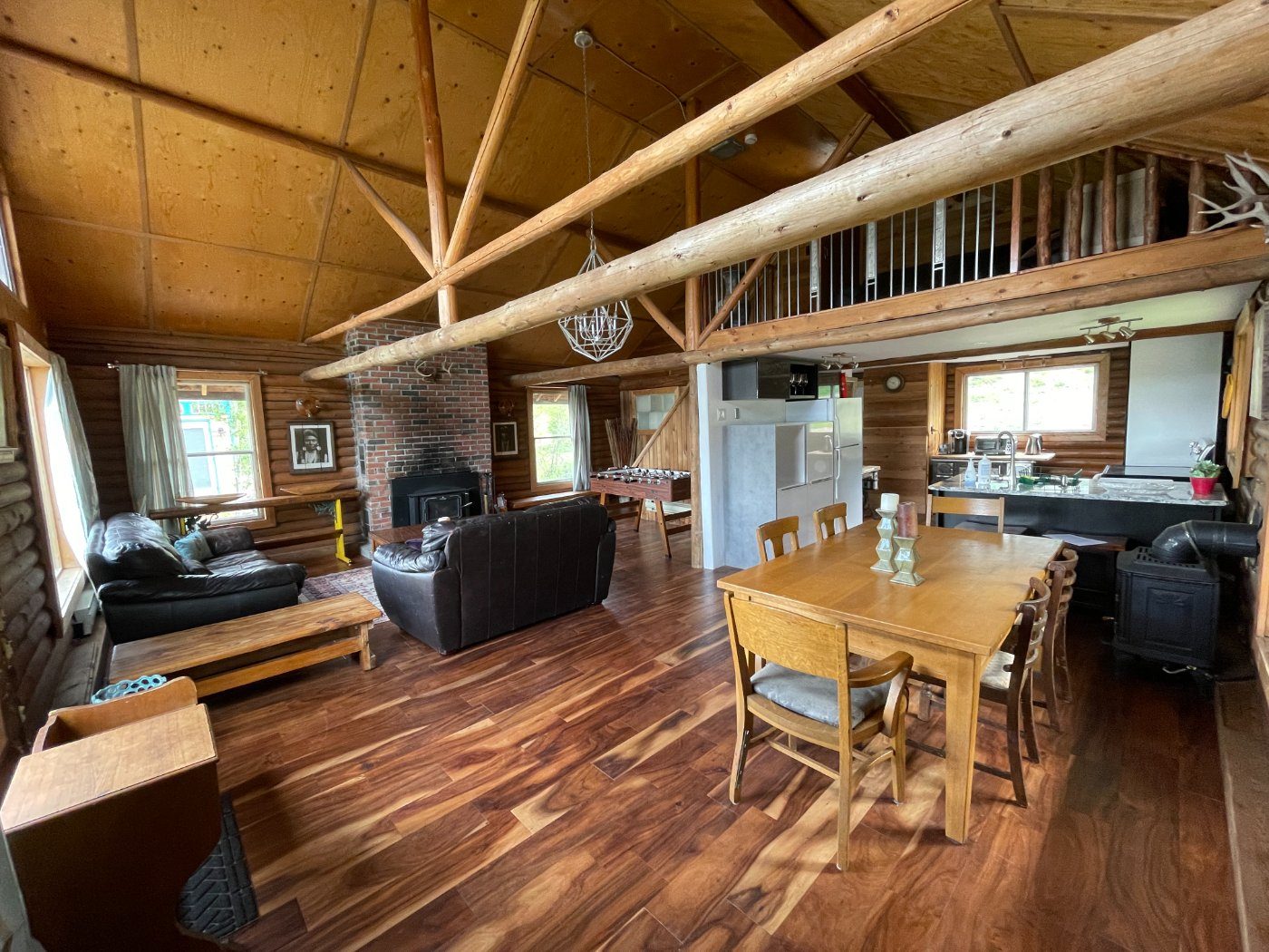 The open living and dining area beneath the log trusses