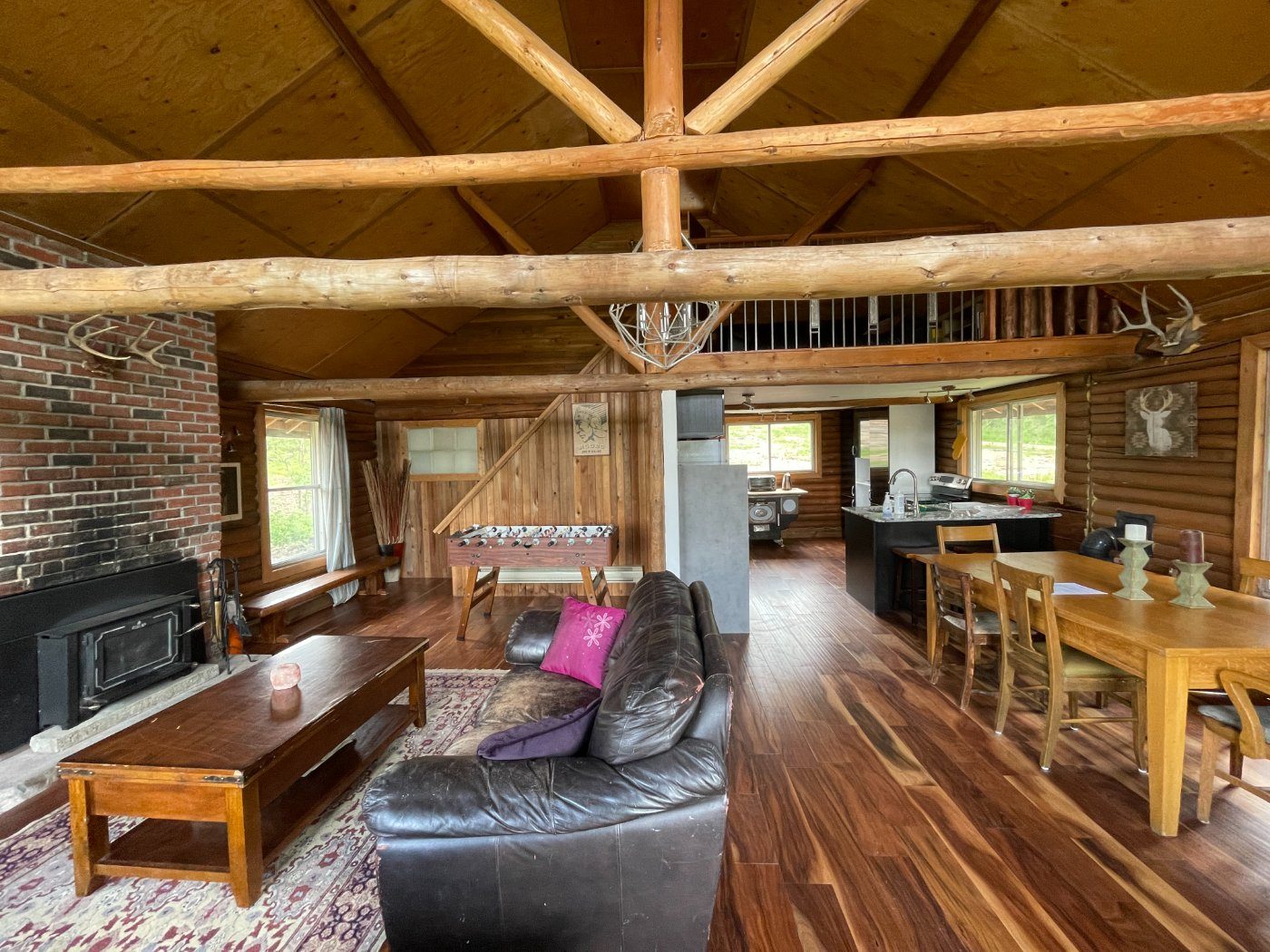 The great room looking across the woodstove and dining table to the kitchen